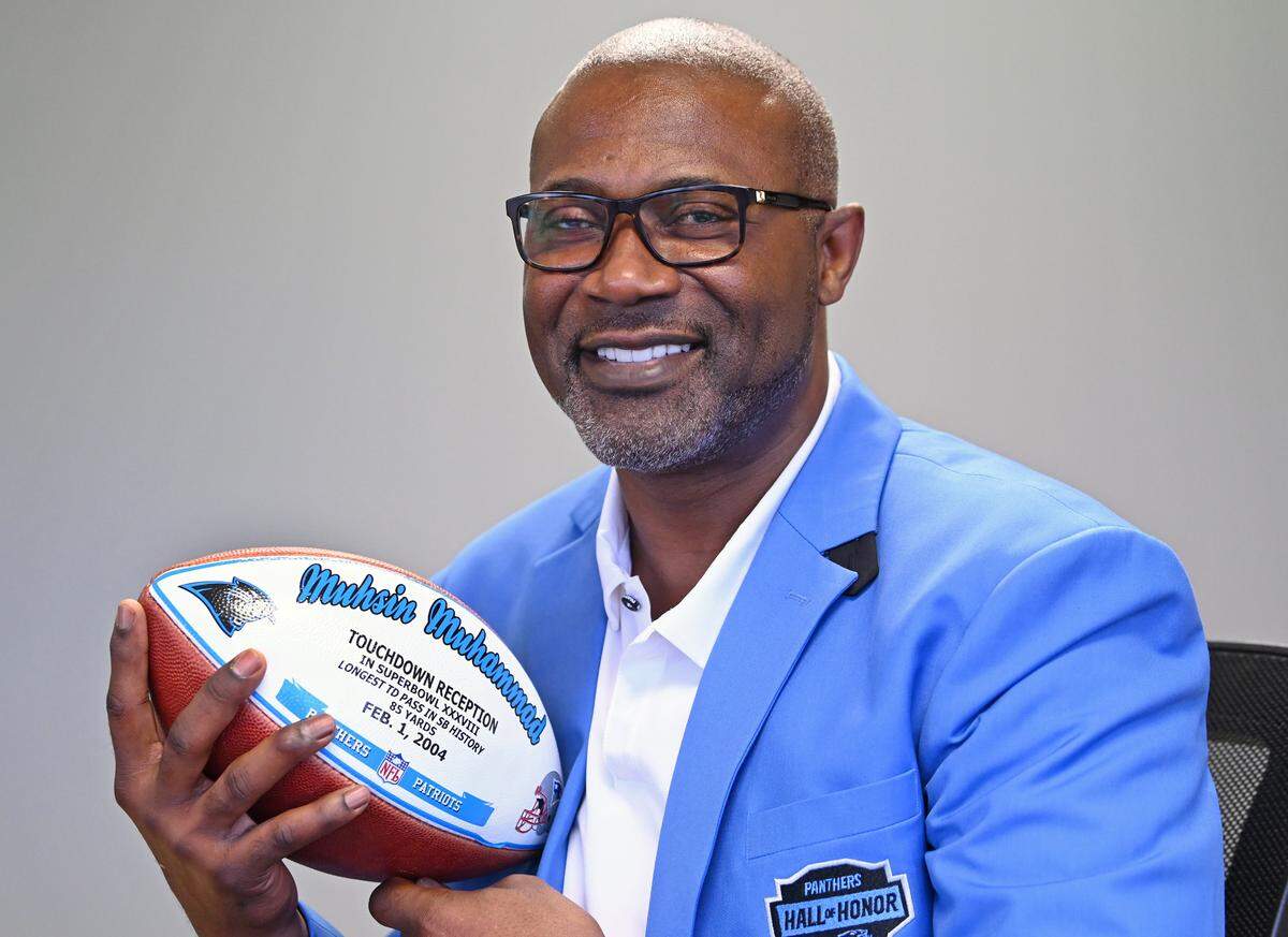 Former Carolina Panthers wide receiver Muhsin Muhammad holds the football he caught for the longest touchdown pass reception in Super Bowl history. The pass from quarterback Jake Delhomme resulted in an 85-yard touchdown.