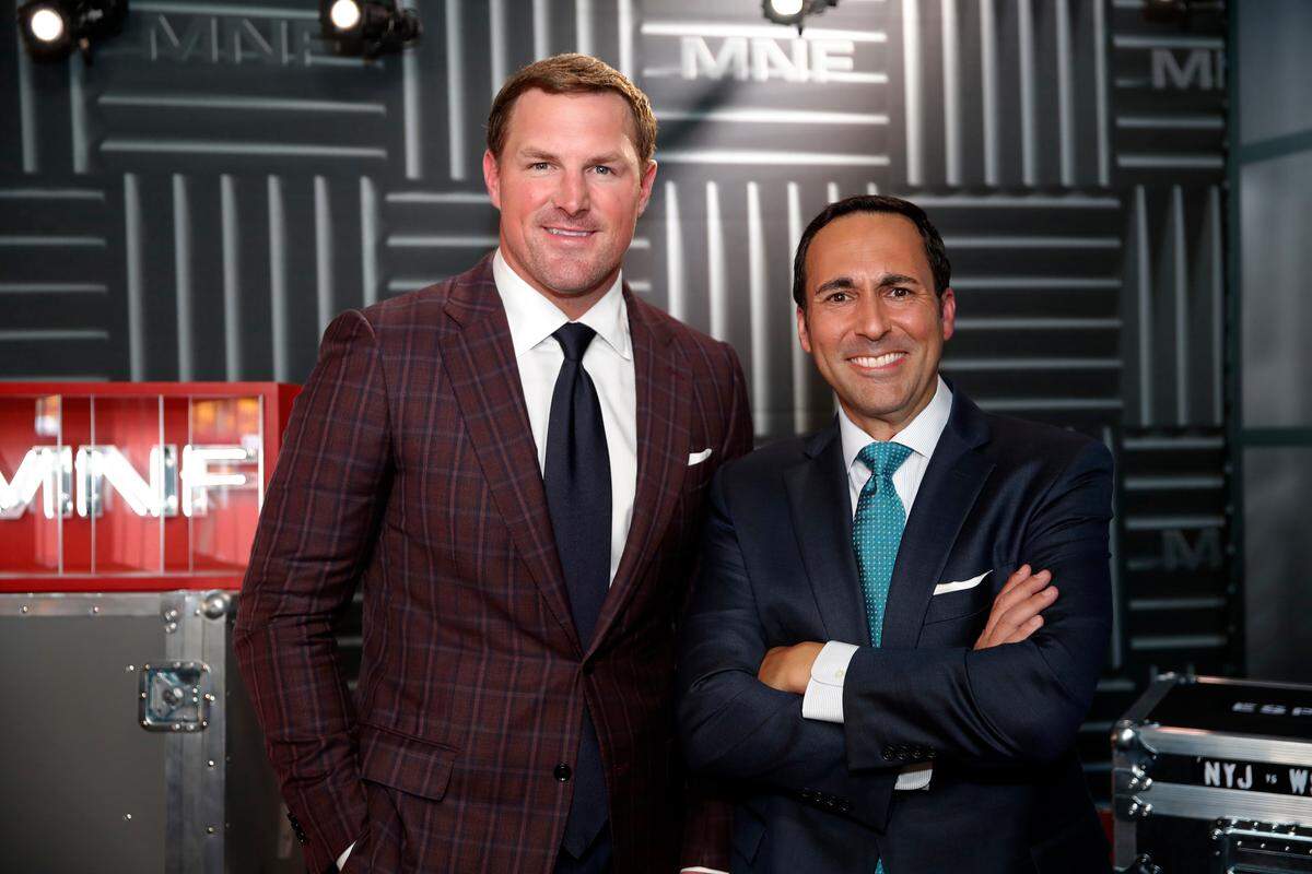 In this Thursday, Aug. 16, 2018, file photo, former NFL player and now analyst Jason Witten, left, and play-by-play commentator Joe Tessitore pose for a photograph before their ESPN telecast of a preseason NFL football game between the Washington Redskins and the New York Jets in Landover, Md. Witten holds one of the most prominent television jobs in the sport as the lead analyst for Monday Night Football.” Witten is approaching his new role in similar fashion as he did his old one when his comprehensive film work made him the second most productive tight end in NFL history. (AP Photo/Alex Brandon, File)