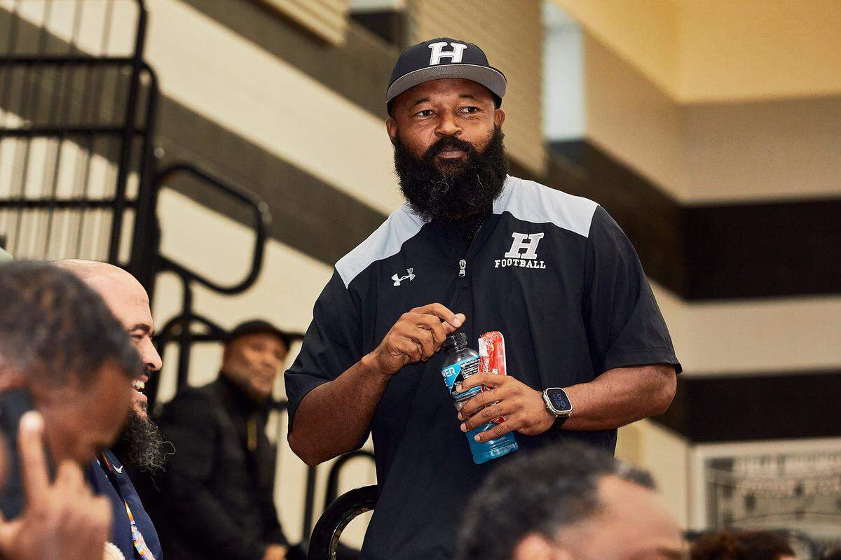 Hough Huskies’ Defensive Coordinator Steve Williams looks on as Hough High's LJ Porter, a top high school football recruit in North Carolina, announces his college decision to East Carolina at Hough High School in Cornelius, NC.