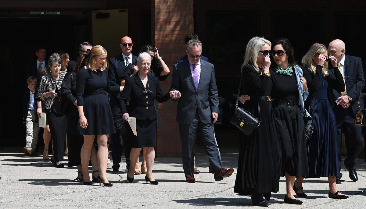 Pat Wheeler, center, and family members exit St. Gabriel Catholic Church in Charlotte following the funeral of her husband, H.A. “Humpy” Wheeler, Jr., on Tuesday, August 26, 2025. 