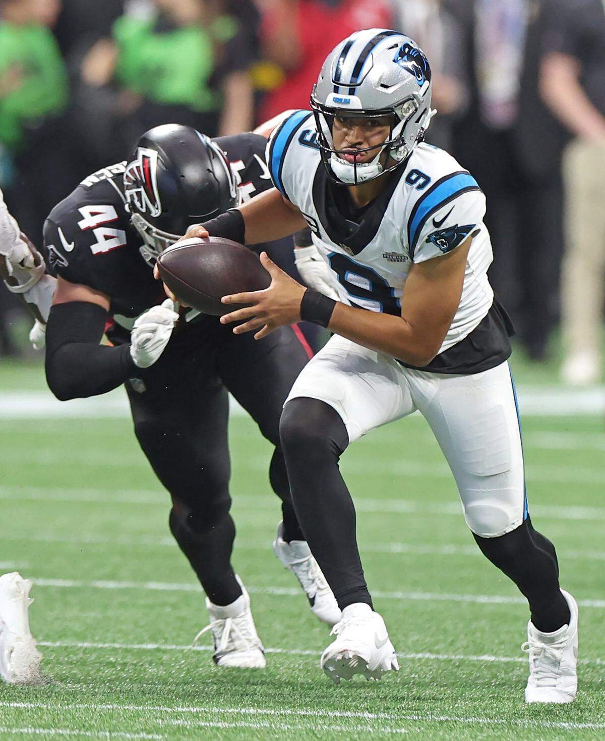 Carolina Panthers quarterback Bryce Young, center, scrambles out of the pocket on a run during fourth-quarter action against the Atlanta Falcons at Mercedes-Benz Stadium in Atlanta, GA on Sunday, September 10, 2023. The Falcons defeated the Panthers 24-10.