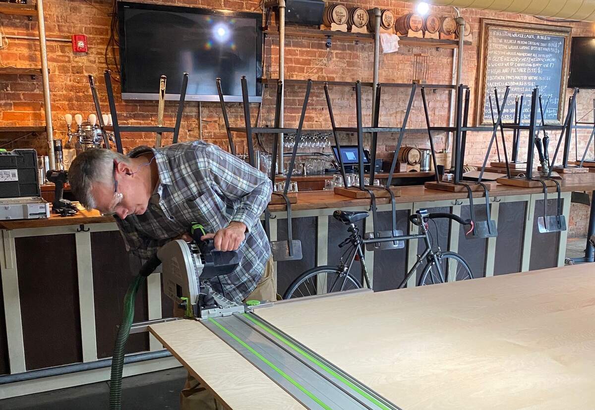 Jeff Tonidandel works on building shelves at Growlers Pourhouse.