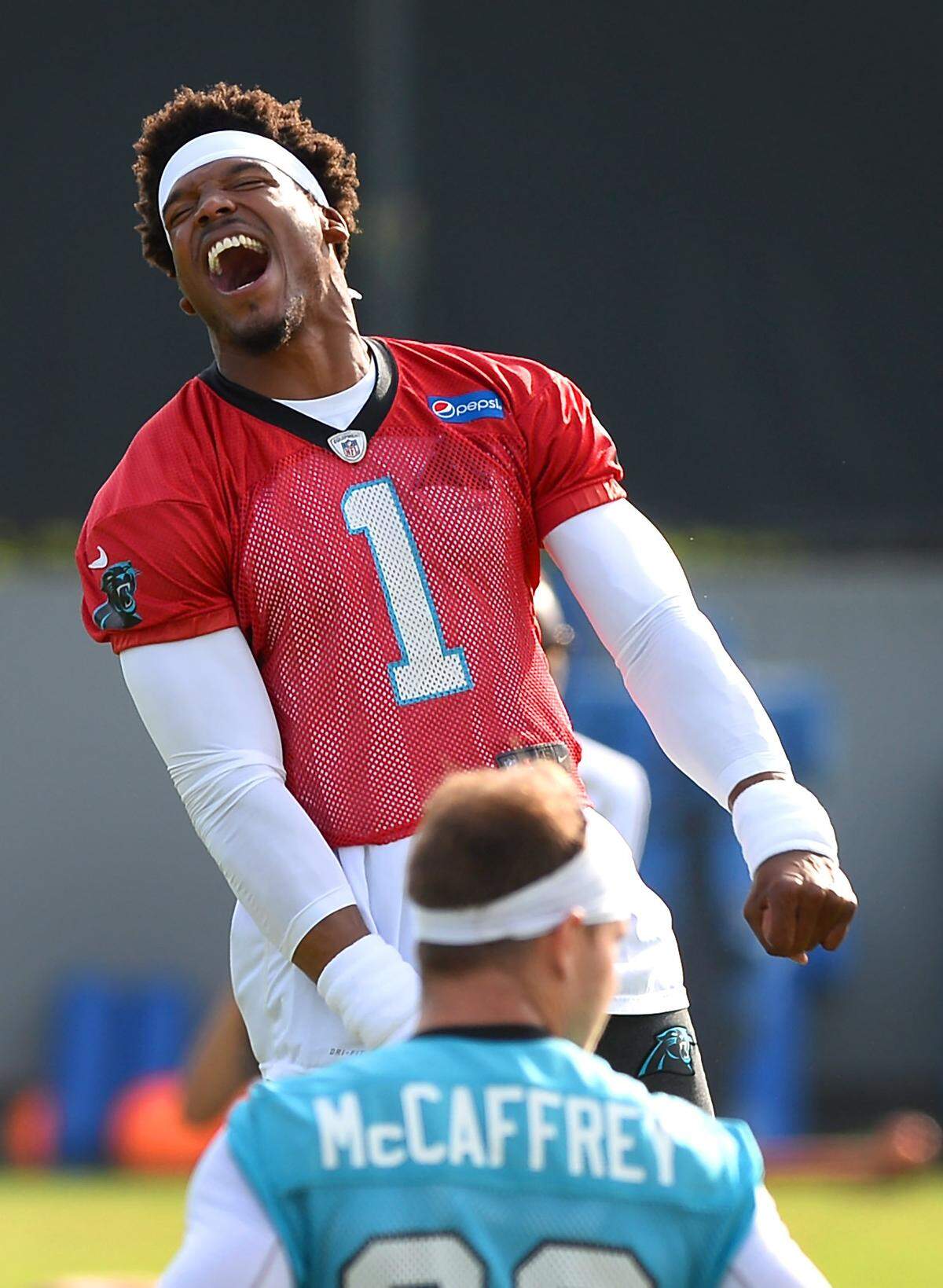 Carolina Panthers quarterback Cam Newton, right, jokes with his teammates as they stretch during the team’s final practice of their three day minicamp on Thursday, June 14, 2018.  Newton is fully healthy heading into training camp next week