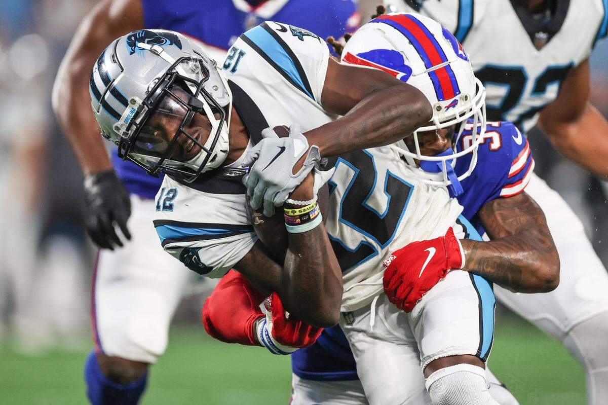 Panthers wide receiver Shi Smith fights to hold onto the ball during the game against the Bills at Bank of America Stadium on Friday, August 26, 2022 in Charlotte, NC.