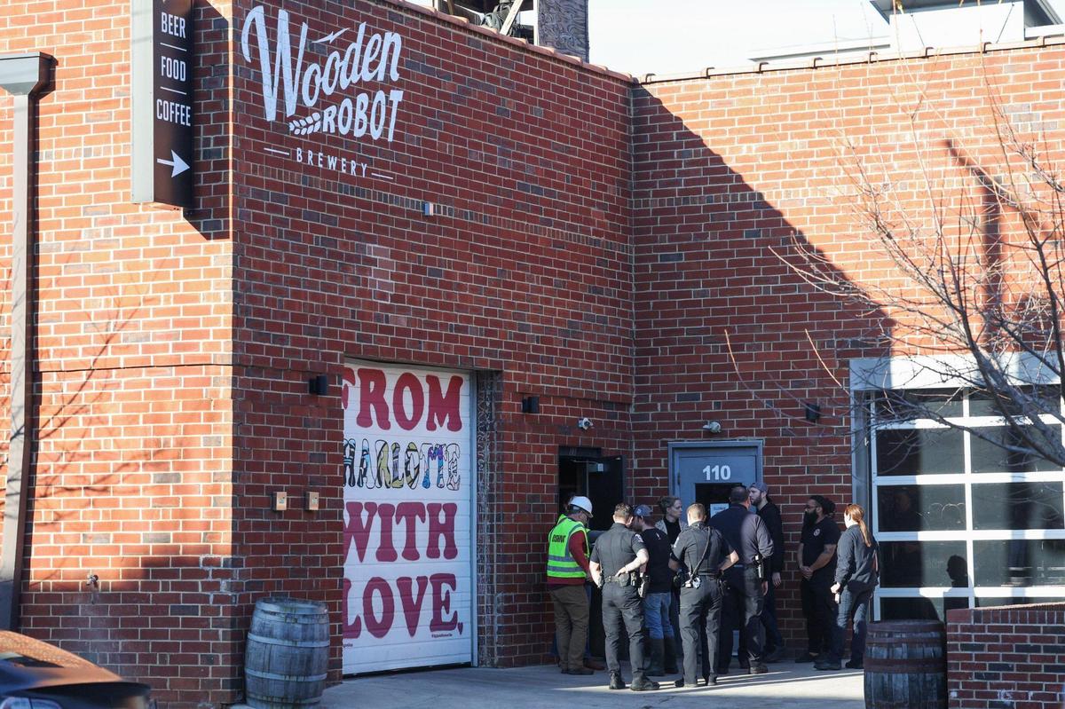 CMPD and the CSI unit are seen outside Wooden Robot Brewery on S. Tryon St. in Charlotte, NC on Tuesday, February 20, 2024. Wooden Robot Brewery closed earlier today amid an ongoing investigation after a deadly fall at the South End location, officials said.