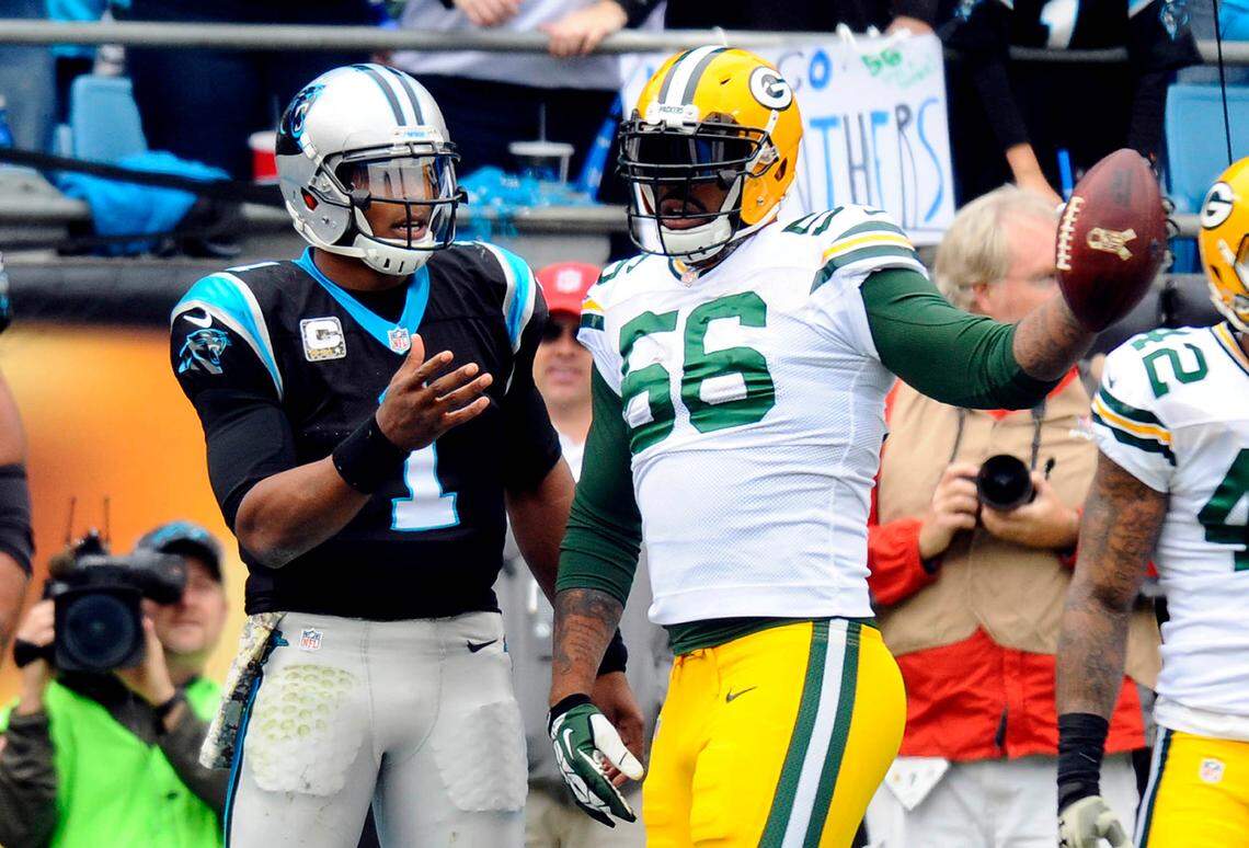 Green Bay’s Julius Peppers, right, plays keep-away with Cam Newton after the Carolina quarterback scored against the Packers in November 2015.