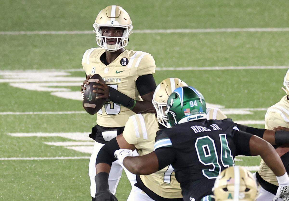 Charlotte 49ers quarterback Deshawn Purdie, center, looks for an open receiver during action against Tulane on Thursday, October 31, 2024 at Jerry Richardson Stadium in Charlotte, NC.