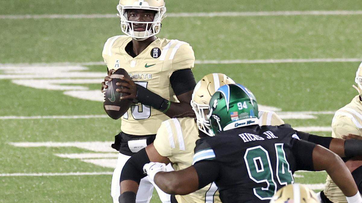 Charlotte 49ers quarterback Deshawn Purdie, center, looks for an open receiver during action against Tulane on Thursday, October 31, 2024 at Jerry Richardson Stadium in Charlotte, NC.