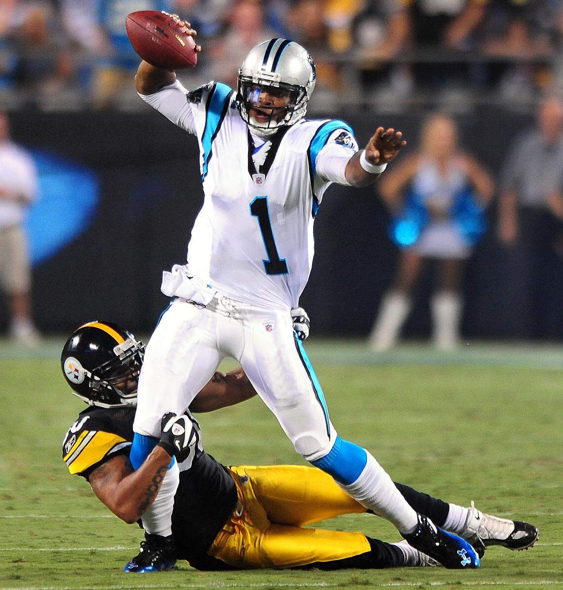 Panthers quarterback (1) Cam Newton fights to get a pass off as Pittsburgh Steelers (50) linebacker Larry Foote tries to sack him during his rookie season in 2011. Newton set NFL rookie passing records that year.