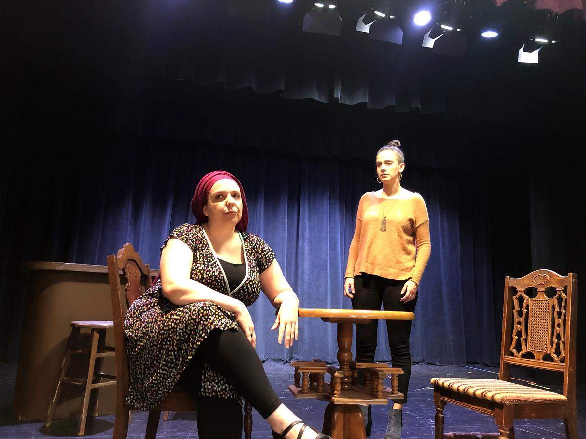 Amanda Liles (left) plays Rachel and Karina Caporino plays Angie during a rehearsal for “The Sabbath Girl,” which opens Nov. 9 at the Levine Jewish Community Center in Charlotte.