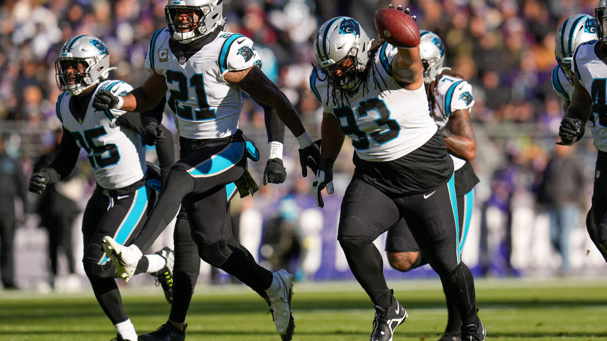 Carolina Panthers defensive tackle Bravvion Roy (93) runs with teammates after making an interception against the Baltimore Ravens during the first half at M&T Bank Stadium.