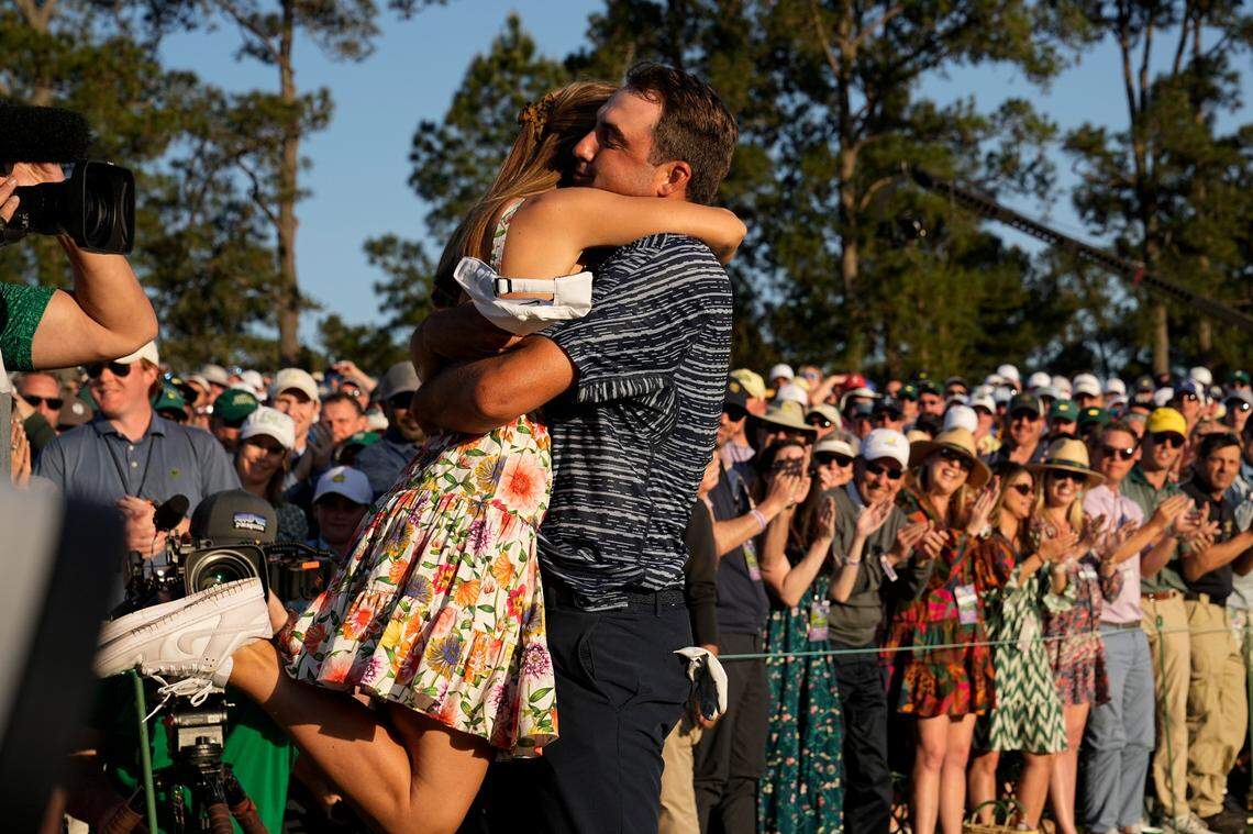 Scottie Scheffler lifts his wife Meredith Scudder off her feet after winning the 86th Masters golf tournament on Sunday, April 10, 2022, in Augusta, Ga. (AP Photo/David J. Phillip)
