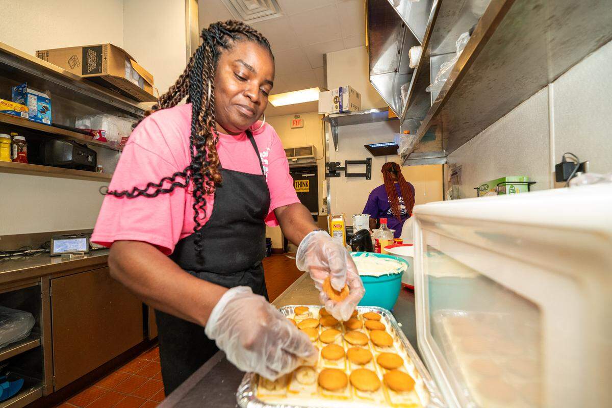 Naomi Bryant finishes making a large batch of banana pudding at Bryant Seafood Market.
