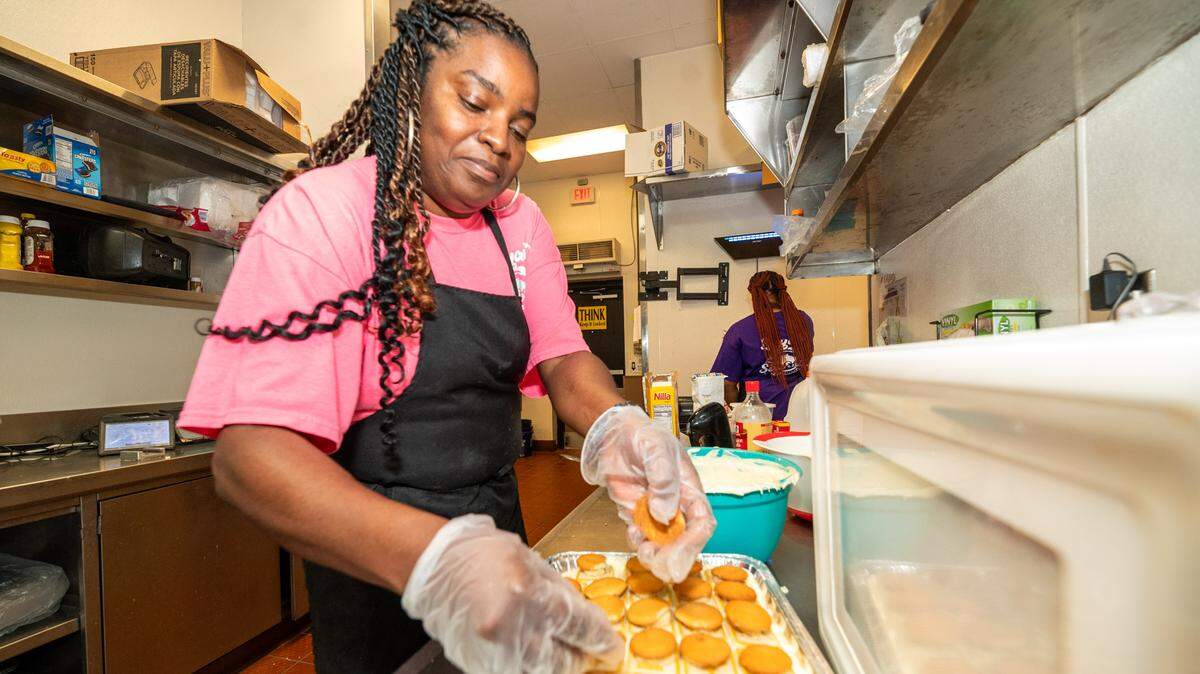 Naomi Bryant finishes making a large batch of banana pudding at Bryant Seafood Market.