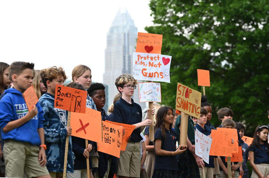 Trinity Episcopal School students hold signs during a walk out on Wednesday to demand action on gun violence and gun safety.