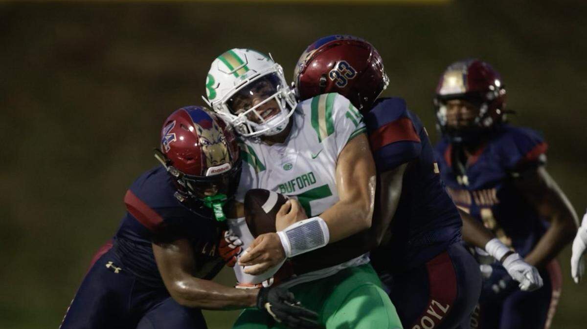 Mallard Creek defenders sack Buford QB Dylan Raiola during the game Friday night.