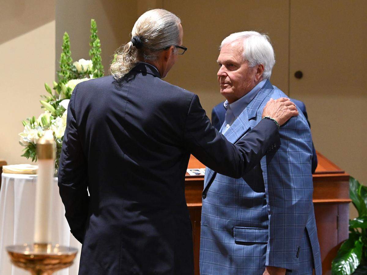 Former NASCAR driver Kyle Petty, left and NASCAR team owner Rick Hendricks, right, speak in the foyer of St. Gabriel Catholic Church in Charlotte prior to the funeral for H.A. “Humpy” Wheeler, Jr., on Tuesday, August 26, 2025. 