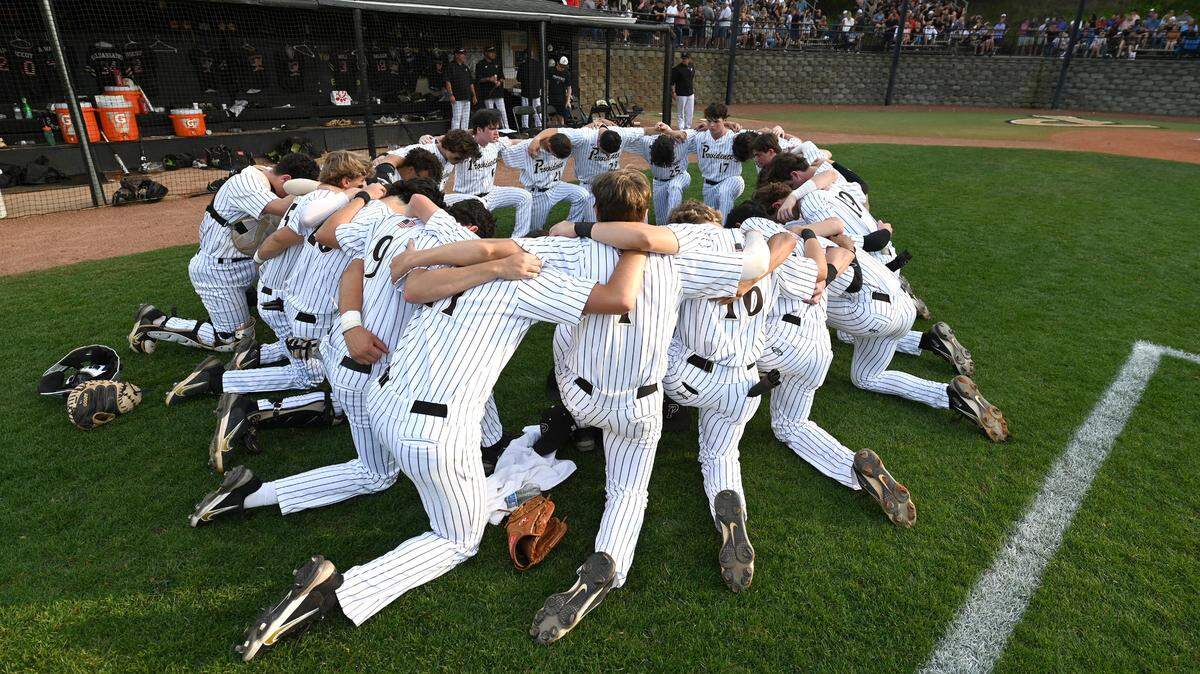 The Providence Panthers baseball team gather in prayer prior to the teamÕs game against the Ardrey Kell Knights on Friday, April 22, 2022. The Panthers defeated the Knights 2-1.
