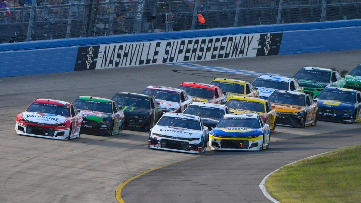 Kyle Larson, far left, and William Byron lead as Chase Elliott, front right, goes low to try to pass during a NASCAR Cup Series auto race Sunday, June 20, 2021, in Lebanon, Tenn. (AP Photo/John Amis)