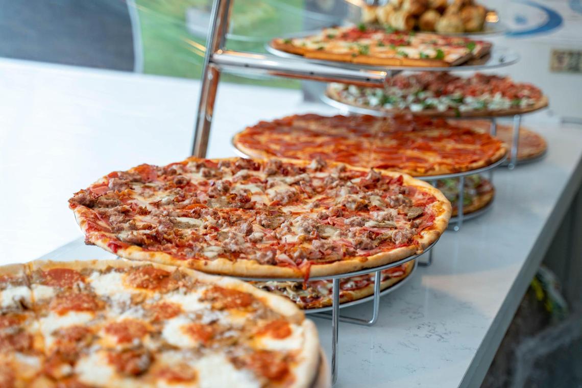 Pizzas are lined up on display at Sal’s Pizza Factory for daily lunch slices.