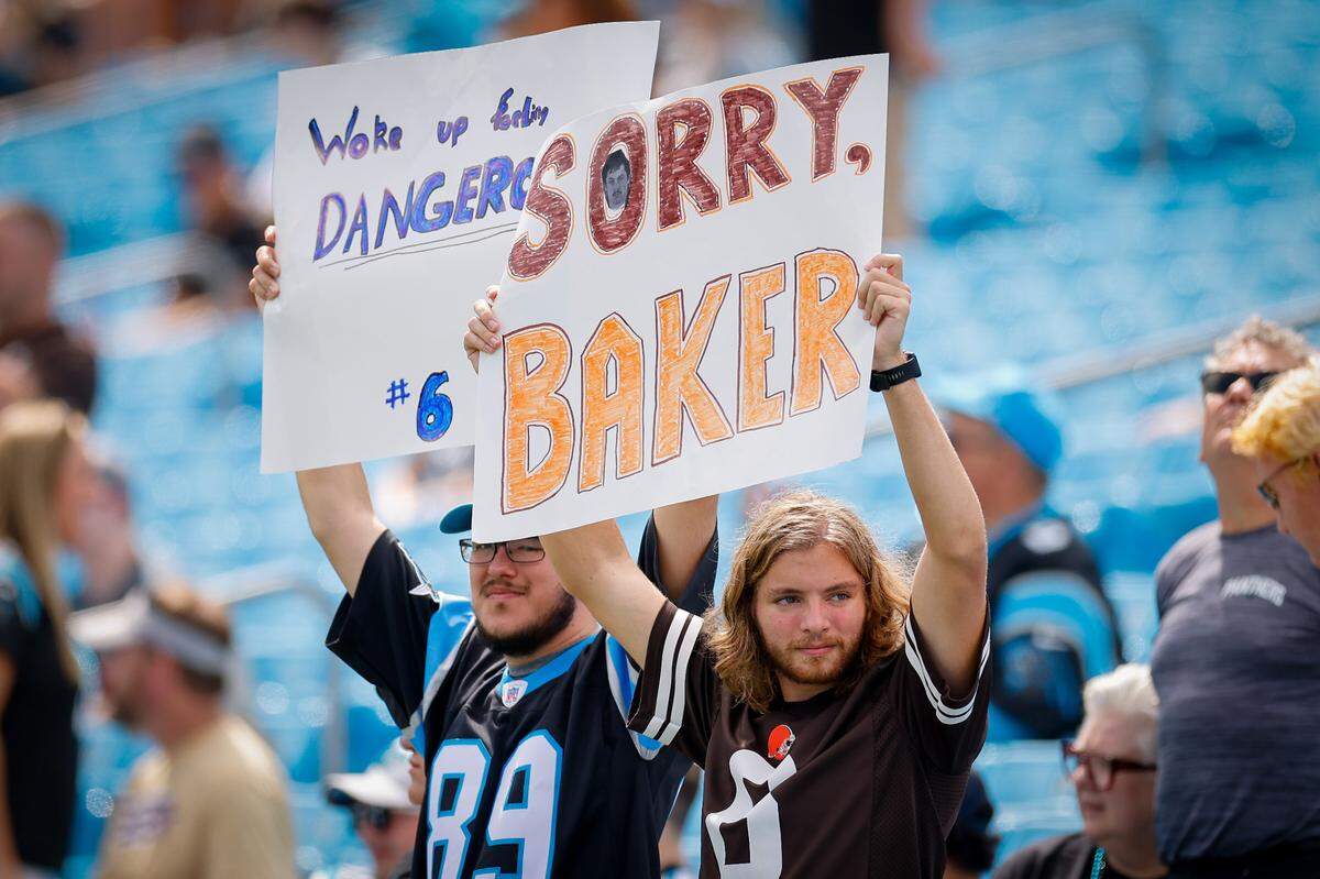 Fans hold up signs before the Carolina Panthers vs. Cleveland Browns NFL game at Bank of America Stadium in Charlotte, NC, on Sunday, Sept. 11, 2022.