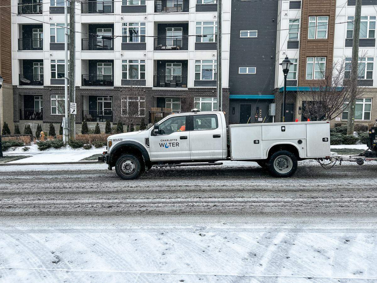A city water utility truck rides down an icy-covered 36th Street in NoDa in Charlotte early Sunday morning on January 25, 2026.