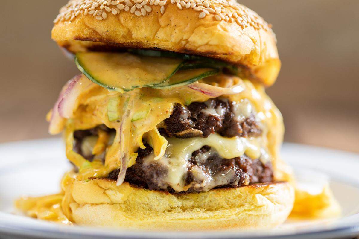 The Goodyear House has a Goopy Burger with Shipley Farms beef, cheddar, pickles, onion, goopy lettuce on a benne seed bun.
