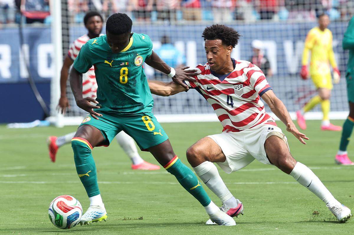 Senegal's midfielder Lamine Camara, left, attempts to block USMNT'S Tyler Adams, right, from stealing the ball during action on Sunday, May 31, 2026 at Bank of America Stadium in Charlotte, NC. USMNT defeated Senegal 3-2.