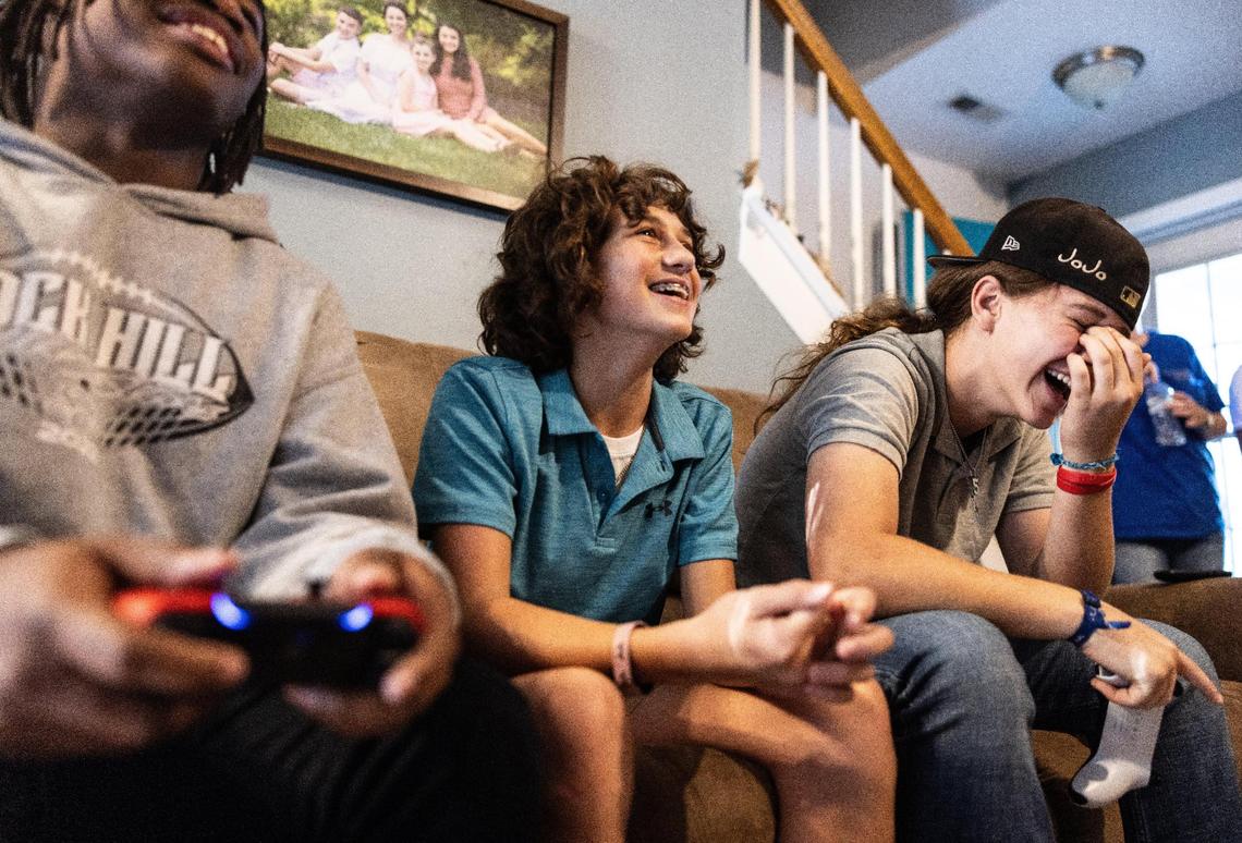 “There’s a bunch of girls who came out for our spring training,” says Jo, pictured at right while playing video games with Sullivan teammates Reece Nahrgang (center) and Dontavious Cousar. “They came for the first day, found out how hard our conditioning was, and then never came back. Their helmets are still hanging up in the locker room.”