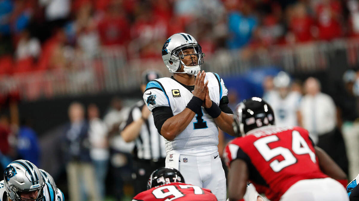 Carolina quarterback Cam Newton (1) pauses before a play against the Atlanta Falcons Sunday.  While much of the Carolinas was dealing with storm relief, the NFL schedule had the Panthers playing a road game 250 miles from Charlotte.