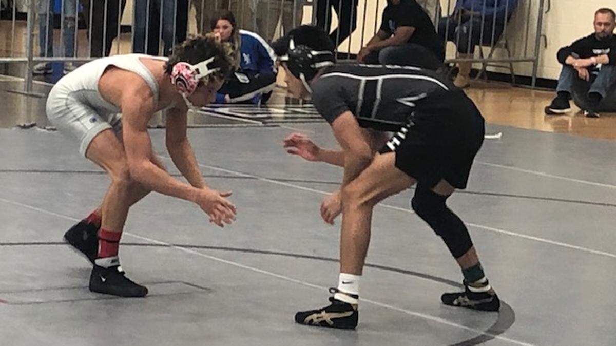 Jun Figueredo wrestles against McDowell’s Tobias Finn in Saturday’s 132-pound final in the 4A regional at Hough