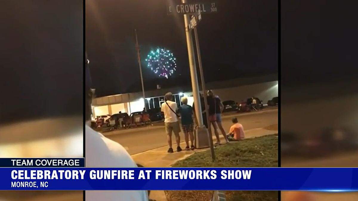 In this screenshot of WSOC video, spectators watch the Fourth of July fireworks show in Monroe, NC, before they hear shots nearby on Monday, July 4, 2022. Police turned to the public for help after saying they have no suspects.