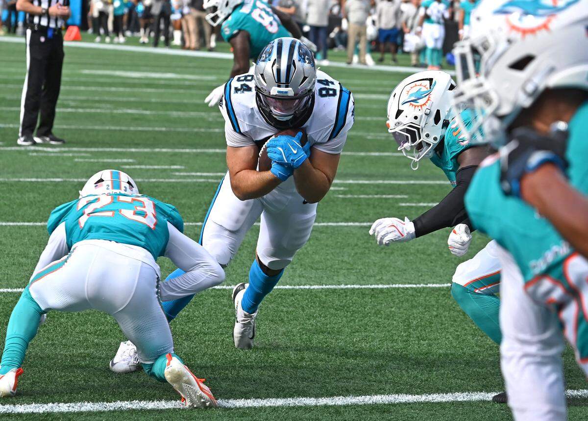 Carolina Panthers tight end Mitchell Evans, center, dives toward the goal line following a pass reception during fourth quarter action against the Miami Dolphins on Sunday, October 5, 2025 at Bank of America Stadium in Charlotte, NC. The Panthers defeated the Dolphins 27-24.