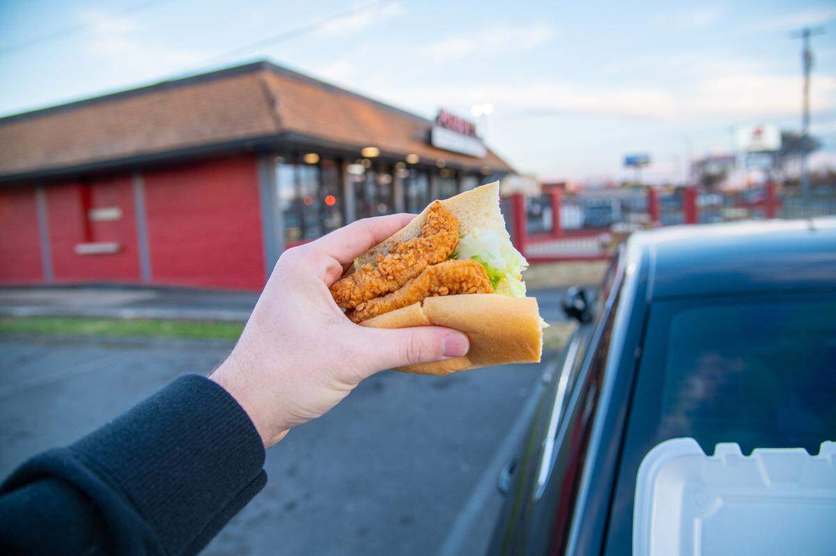 Po Boy’s Low Country Seafood Market’s Fried Chicken Po Boy puts together chicken tenders and a superior hoagie roll to make magic. This photo shows only half of the sizeable sandwich.