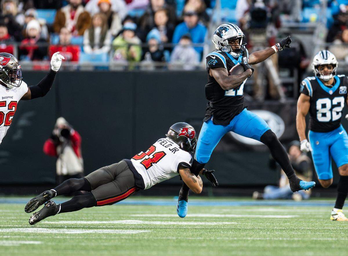 Carolina Panthers wide receiver Xavier Legette, right, is pulled down by Tampa Bay Buccaneers safety Antoine Winfield Jr. at the Bank of America Stadium in Charlotte on Sunday, December 1, 2024.