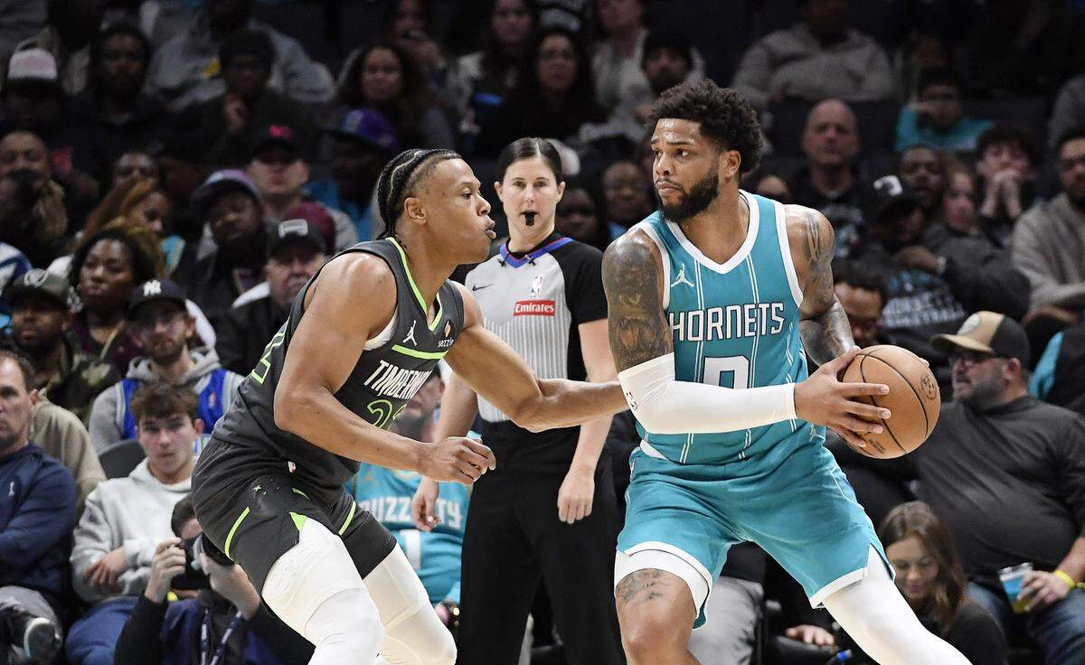 Charlotte Hornets forward Miles Bridges (0) controls the ball as Minnesota Timberwolves guard Jaylen Clark (22) defends during the second half at the Spectrum Center. 
