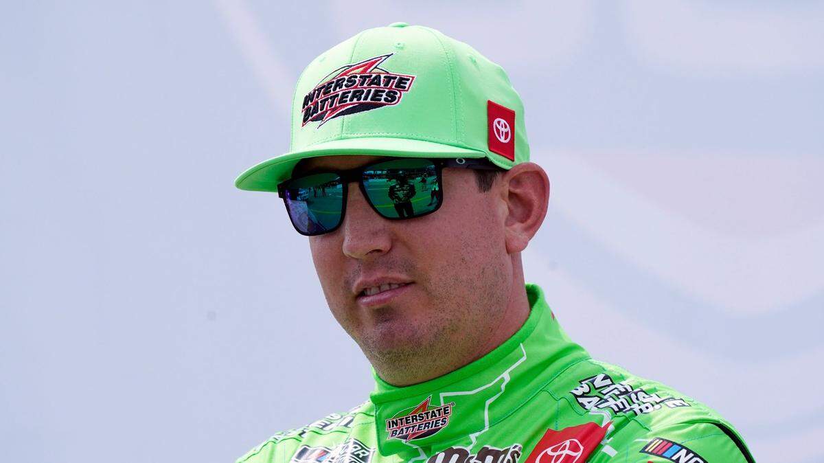 Kyle Busch talks with other drivers before driver introductions at the NASCAR Cup Series auto race at Michigan International Speedway, Sunday, Aug. 22, 2021, in Brooklyn, Mich. (AP Photo/Carlos Osorio)