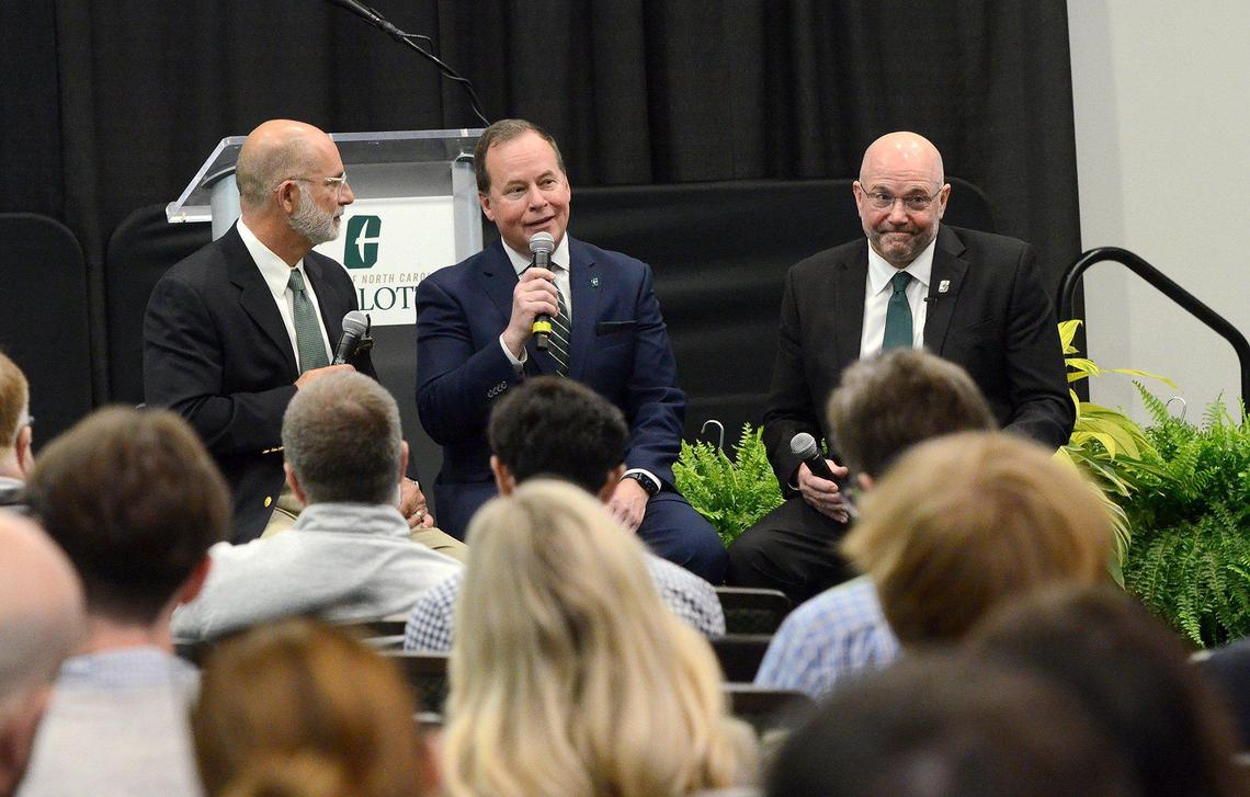 Charlotte athletic director Mike Hill (center) and newly signed head football coach, Tim Albin (right), took questions from the media Monday.