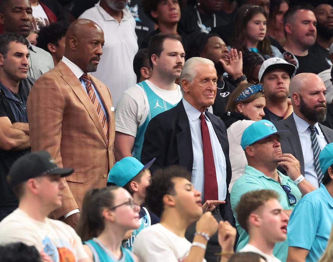 NBA legends Alonzo Mourning, left and Pat Riley, right, watch the Miami Heat battle the Charlotte Hornets at Spectrum Center in Charlotte, NC on Tuesday, April 14, 2026. The Hornets defeated the Heat 127-126 in NBA Play-in-Tournament basketball game.