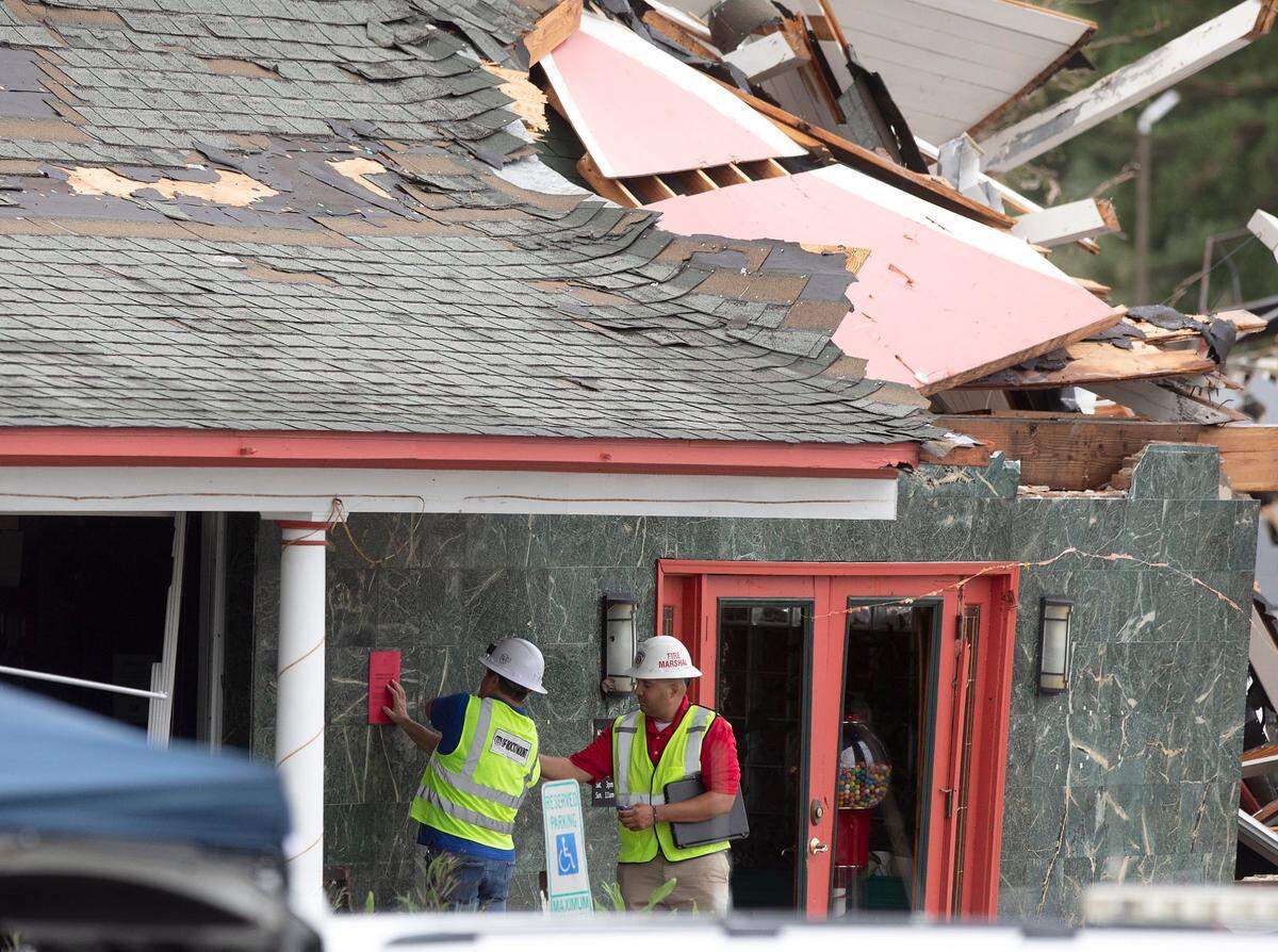 Officials work outside of Hing Ta Restaurant after the building sustained damage during a tornado in Rocky Mount, N.C. on Friday, Sept. 27, 2024. 