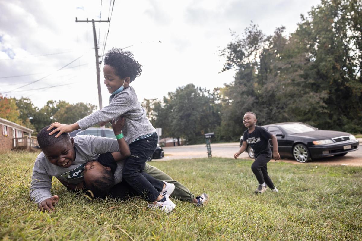 Kids play in a yard in the Smithville neighborhood in Cornelius, N.C., on Tuesday, October 11, 2022.