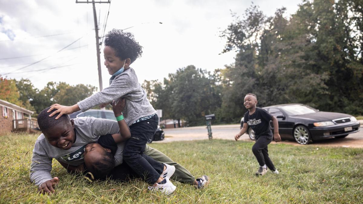 Kids play in a yard in the Smithville neighborhood in Cornelius, N.C., on Tuesday, October 11, 2022.