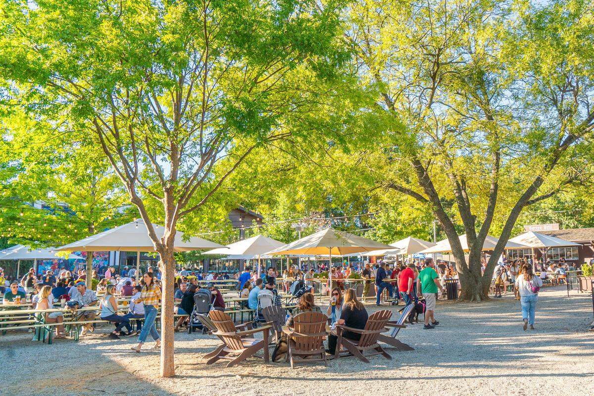 Olde Mecklenburg Brewery customers enjoy German-style beer outside the business in Charlotte. Madison Communities is planning to build more than 300 apartments near its Lower South End location.