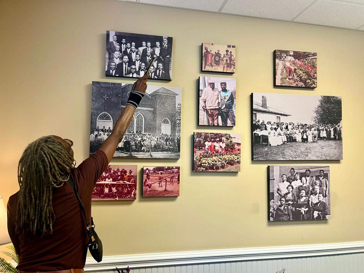 Lisa Mayhew-Jones, the interim executive director of the Smithville CommUNITY Coalition, points toward past residents of Smithville, an historically Black community in Cornelius.