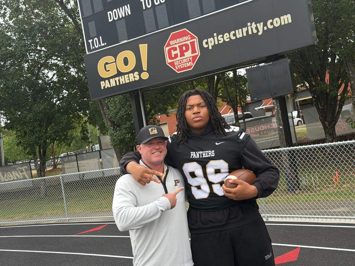 Providence High defensive lineman Cory Cunningham (right) and Panthers’ head coach Wes Ward