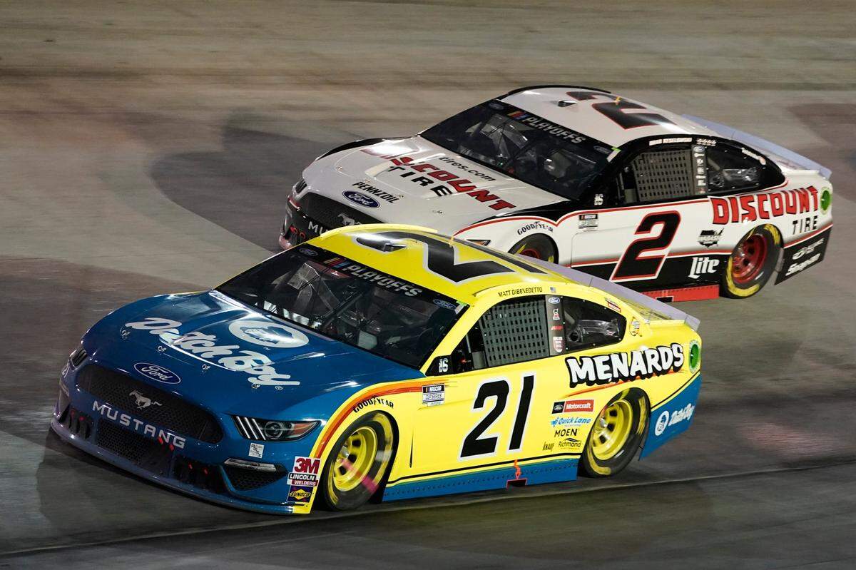 Matt DiBenedetto (21) and Brad Keselowski (2) drive into Turn 1 during the NASCAR Cup Series auto race Saturday, Sept. 19, 2020, in Bristol, Tenn. (AP Photo/Steve Helber)
