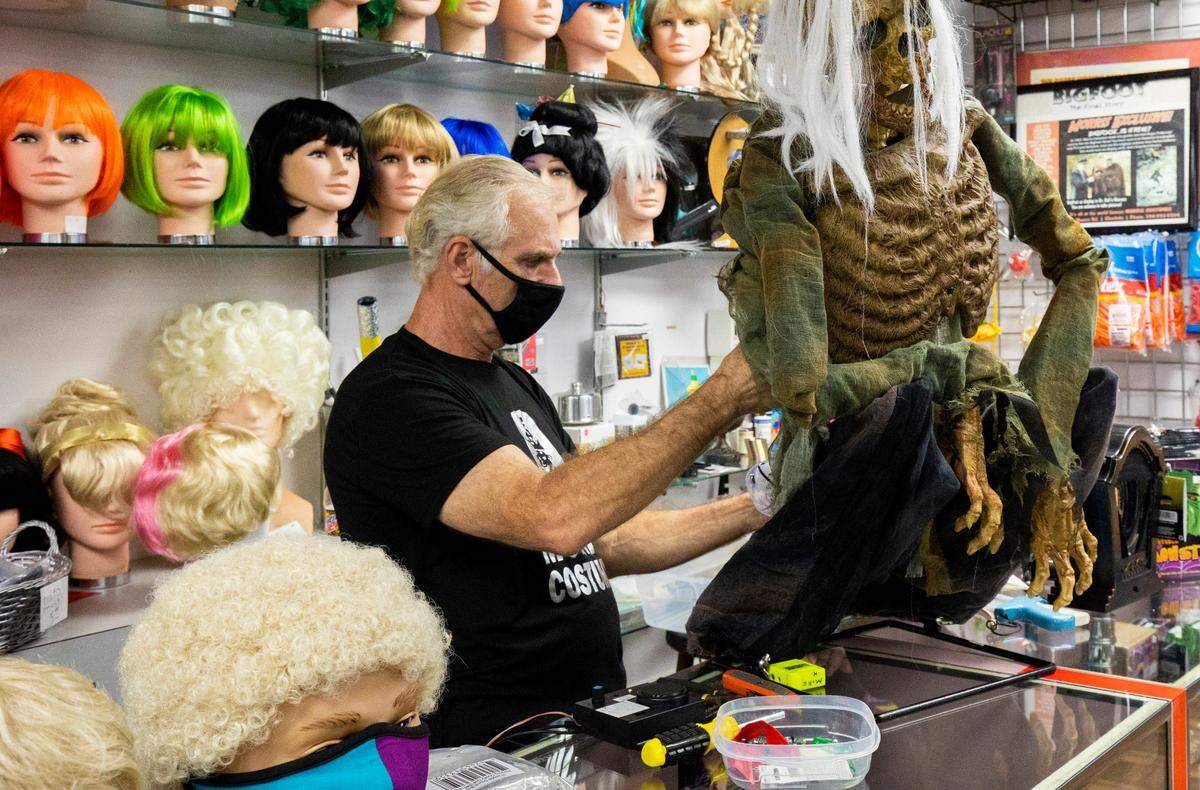 Original: Mike Hoffman, a longtime employee at Morris Costumes in Charlotte, works on an animated character display Wednesday, Oct. 14.