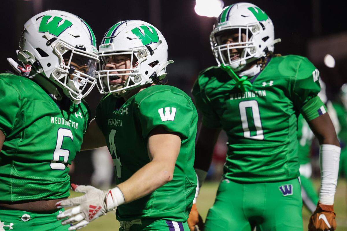 Weddington’s Aiden Harris (6) celebrates scoring two points on a safety with teammates Gannon Anthony (4) and TJ Davis (0) during the third round of the NC 4A playoffs against Charlotte Catholic at Weddington High School on Friday, November 17, 2023.
