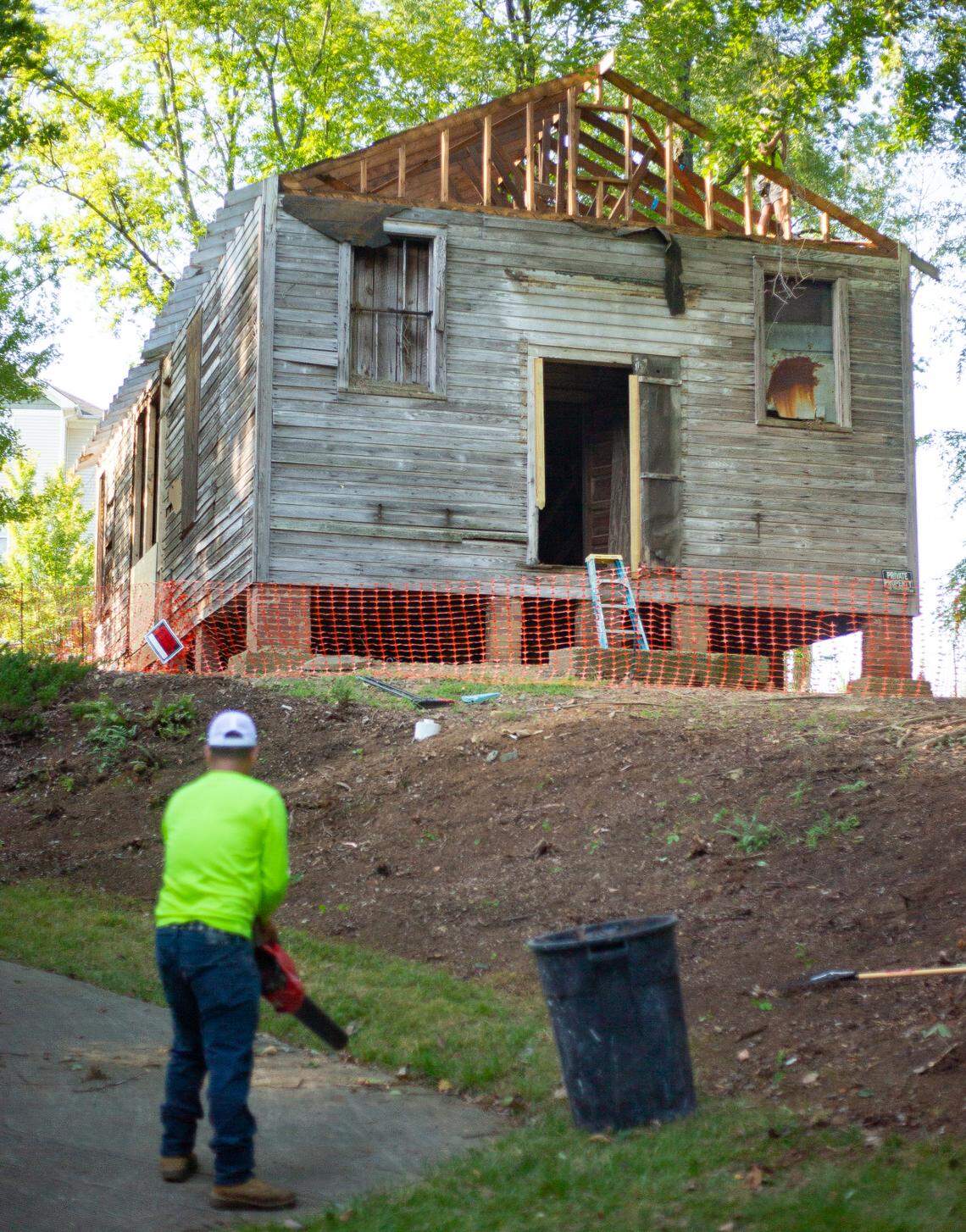 Crews remove the roof from the historic Siloam School ahead of its transport to the Charlotte Museum of History, where it will be restored as a community resource to preserve its legacy.