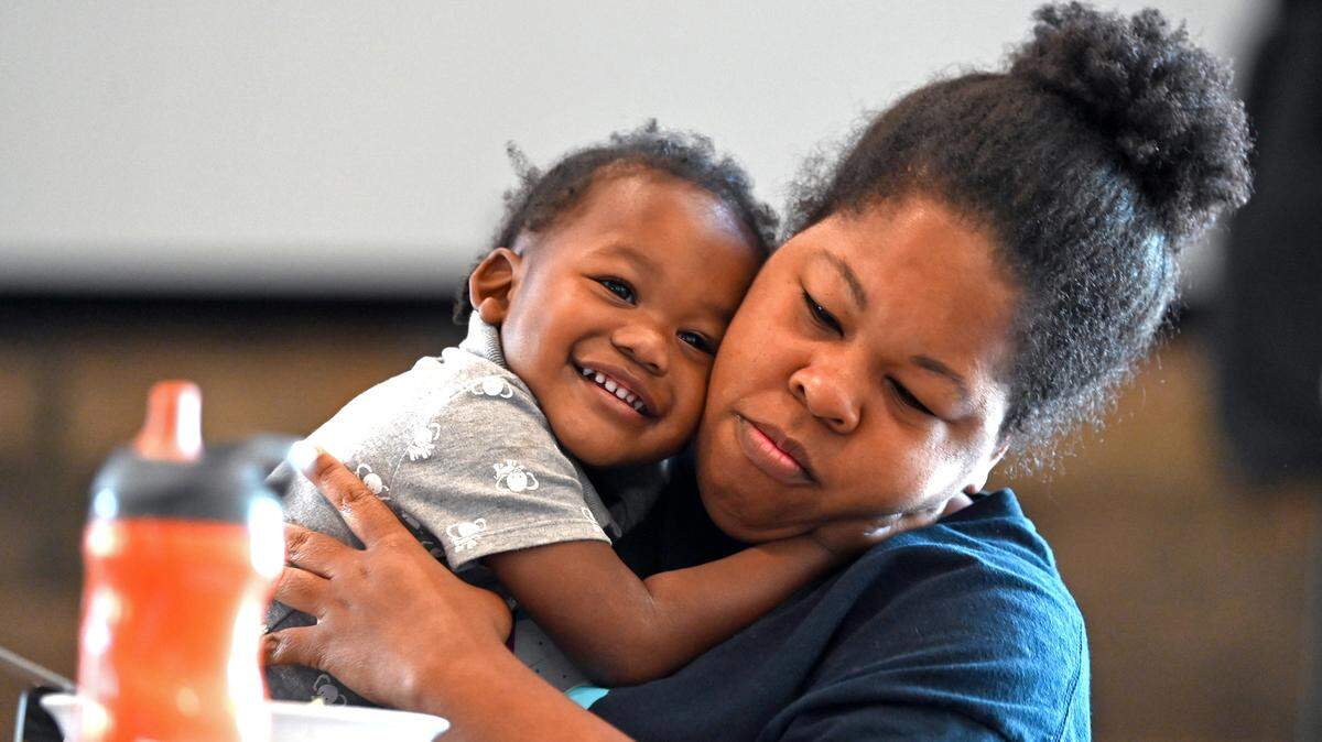 Ezekiel Faggart, 2, hugs his mother, LaTonda Faggart as they enjoy lunch at FeedNC on Tuesday, October 24, 2023. FeedNC formerly known the Mooresville Soup Kitchen relies 100% on community donations to provide breakfast, lunch and groceries to people in need each week day. FeedNC offers culinary and warehouse jobs. The program’s classes are 12-week programs.